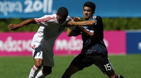 Argentina's Lucas Villafanez, right, fights for the ball with Cuba's Dayron Blanco during a men's soccer match at the Pan American Games in Guadalajara, Mexico, Sunday, Oct. 23, 2011. Argentina won 1-0. (AP Photo/Juan Karita)