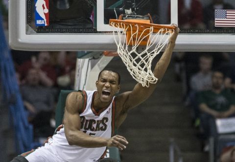 Milwaukee Bucks' Chris Wright reacts to his alley-oop dunk against the Indiana Pacers during the second half of an NBA basketball game on Wednesday, April 9, 2014, in Milwaukee. (AP Photo/Tom Lynn)  ORG XMIT: WITL110