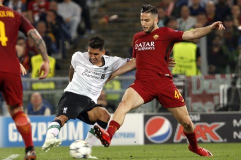 Liverpool's Roberto Firmino, left, is challenged by Roma's Kostas Manolas during the Champions League semifinal second leg soccer match between Roma and Liverpool at the Olympic Stadium in Rome, Wednesday, May 2, 2018. (AP Photo/Riccardo De Luca)