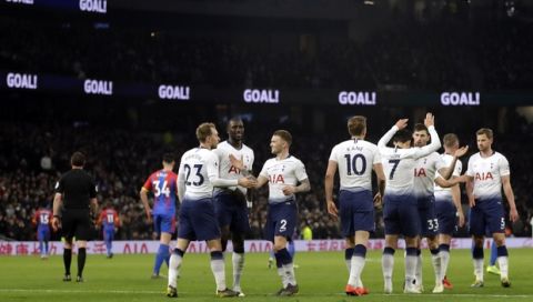 Tottenham's Christian Eriksen, foreground left, celebrates after scoring his side's second goal during the English Premier League soccer match betweenTottenham Hotspur and Crystal Palace, the first Premiership match at the new Tottenham Hotspur stadium in London, Wednesday, April 3, 2019. (AP Photo/Kirsty Wigglesworth)