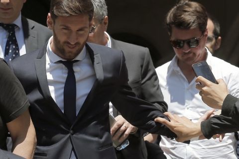 Barcelona soccer player Lionel Messi, left, leaves the court in Barcelona, Spain, Thursday, June 2, 2016. Lionel Messi denied having knowledge of the tax issues that led to fraud charges against him, saying Thursday he signed documents without reading them because he trusted his father and the advisers responsible for managing his finances. I didnt know anything, Messi said while testifying in his tax fraud trial. I only worried about playing football. (AP Photo/Manu Fernandez)