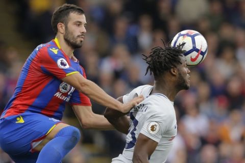 Crystal Palace's Luka Milivojevic, left vies for the ball with Chelsea's Michy Batshuayi during the English Premier League soccer match between Crystal Palace and Chelsea at Selhurst Park stadium in London, Saturday, Oct. 14, 2017. (AP Photo/Alastair Grant)