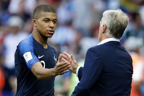 France head coach Didier Deschamps shakes hands with Kylian Mbappe during the round of 16 match between France and Argentina, at the 2018 soccer World Cup at the Kazan Arena in Kazan, Russia, Saturday, June 30, 2018. (AP Photo/David Vincent)