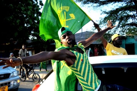 Supporter of the ruling CCM party in Tanzania celebrate after the partys presidential candidate, Dr. John Pombe Magufuli was declared a winner, in Dar es Salaam, Tanzania, Thursday Oct. 29, 2015. Tanzania's ruling party has won the country's presidential election, defeating an opposition alliance that had hoped to end the party's five-decade grip on power, the country's election commission announced on Thursday. (AP Photo/Khalfan Said)