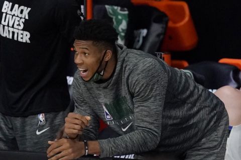 Milwaukee Bucks' Giannis Antetokounmpo, center, shouts from the bench in the first half of an NBA conference semifinal playoff basketball game against the Miami Heat Tuesday, Sept. 8, 2020 in Lake Buena Vista, Fla. (AP Photo/Mark J. Terrill)
