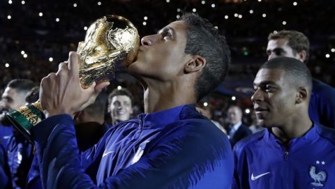 France's Raphael Varane and teammates celebrate with the World Cup trophy during a ceremony following the UEFA Nations League soccer match between France and The Netherlands at the Stade de France stadium in Saint-Denis, outside Paris, France, Sunday, Sept. 9, 2018. (AP Photo/Christophe Ena)