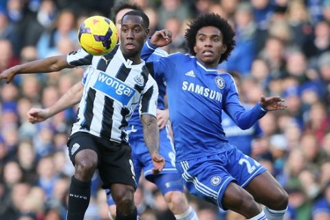 Chelsea's Willian, right, challenges for the ball with Newcastle's Vurnon Anita during their English Premier League soccer match between Chelsea and Newcastle United in London, Saturday, Feb. 8,  2014. (AP Photo/Alastair Grant)