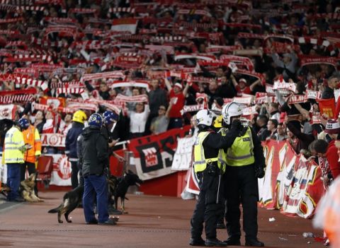 Police forces watch Cologne supporters prior to the Europa League group H soccer match between Arsenal and FC Cologne at the Emirates stadium in London, England, Thursday, Sept. 14, 2017 . (AP Photo/Kirsty Wigglesworth)