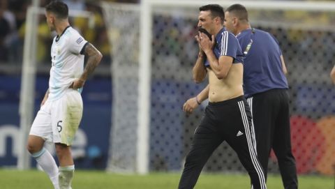 Argentina's coach Lionel Scaloni, right, reacts after losing to Brazil during a Copa America semifinal soccer match at the Mineirao stadium in Belo Horizonte, Brazil, Tuesday, July 2, 2019. Brazil defeated Argentina 2-0 and advances to the final. (AP Photo/Natacha Pisarenko)