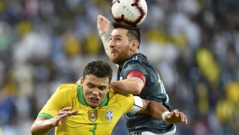Argentina's Lionel Messi, right, heads the ball past Brazil's Thiago Silva during a friendly soccer match between Brazil and Argentina at King Fahd stadium in Riyadh, Saudi Arabia, Friday, Nov. 15, 2019. (AP Photo)