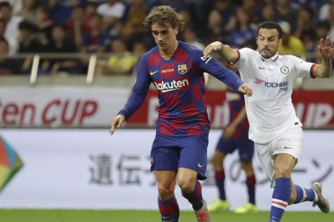 Barcelona's Antoine Griezmann, left, and Chelsea's Pedro, right, compete for the ball during a friendly soccer match between FC Barcelona and Chelsea FC in Saitama, north of Tokyo, Tuesday, July 23, 2019. Chelsea won 2-1. (AP Photo/Eugene Hoshiko)