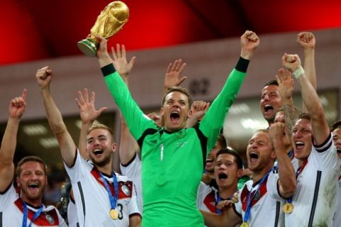 RIO DE JANEIRO, BRAZIL - JULY 13:  Manuel Neuer of Germany lifts the World Cup to celebrate with his teammates during the award ceremony after the 2014 FIFA World Cup Brazil Final match between Germany and Argentina at Maracana on July 13, 2014 in Rio de Janeiro, Brazil.  (Photo by Alex Livesey - FIFA/FIFA via Getty Images)