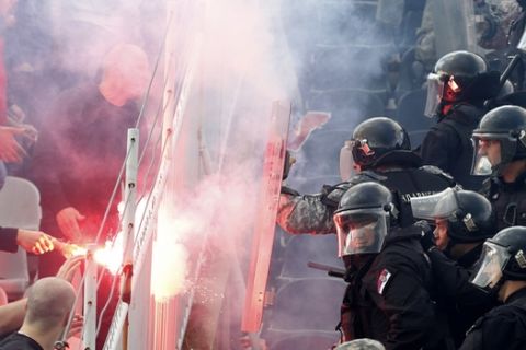 Serbian riot police officers clash with Red Star soccer fans during Serbian National Cup final soccer match between Partizan and Red Star, in Belgrade, Serbia, Saturday, May 27, 2017. (AP Photo/Darko Vojinovic)
