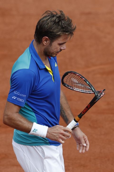 Switzerland's Stan Wawrinka walks back to his bench after deliberately breaking his racket in the men's final match against Spain's Rafael Nadal at the French Open tennis tournament at the Roland Garros stadium, in Paris, France, Sunday, June 11, 2017. (AP Photo/Petr David Josek)