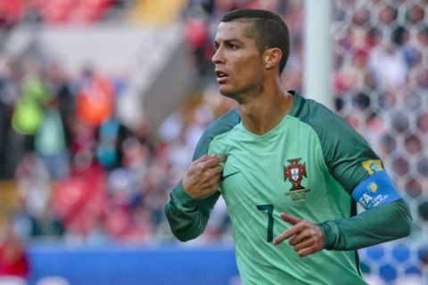 Portugal's Cristiano Ronaldo celebrates after scoring his side's first goal during the Confederations Cup, Group A soccer match between Russia and Portugal, at the Spartak Stadium in Moscow, Wednesday, June 21, 2017. (AP Photo/Ivan Sekretarev)