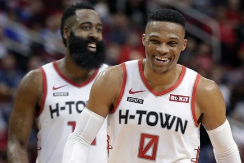 Houston Rockets guards Russell Westbrook (0) and James Harden, behind, laugh after a score against the Atlanta Hawks during the second half of an NBA basketball game, Saturday, Nov. 30, 2019, in Houston. (AP Photo/Michael Wyke)