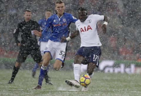 Tottenham Hotspur's Moussa Sissoko vies for the ball with Rochdale's Mark Kitching during the English FA Cup fifth round replay soccer match between Tottenham Hotspur and Rochdale at Wembley stadium in London, Wednesday, Feb. 28, 2018. (AP Photo/Matt Dunham)
