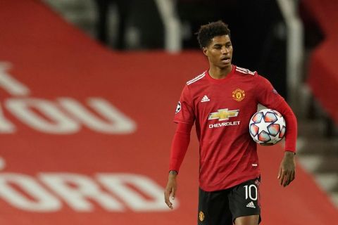 Manchester United's Marcus Rashford walks end of the Champions League group H soccer match between Manchester United and RB Leipzig, at the Old Trafford stadium in Manchester, England, Wednesday, Oct. 28, 2020. (AP Photo/Dave Thompson)