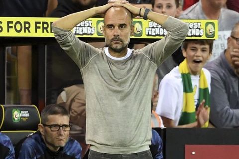 Manchester City manager Pep Guardiola looks dejected on the touchline during the English Premier League soccer match between Norwich City and Manchester City at Carrow Road, Norwich, England, Saturday, Sept. 14, 2019. (Joe Giddens/PA via AP)