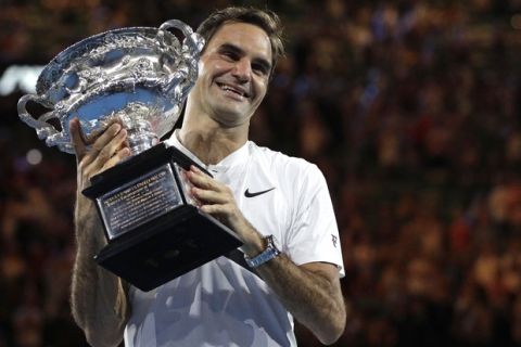 Switzerland's Roger Federer holds his trophy after defeating Croatia's Marin Cilic during the men's singles final at the Australian Open tennis championships in Melbourne, Australia, Sunday, Jan. 28, 2018. (AP Photo/Dita Alangkara)