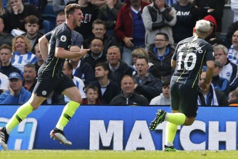Manchester City's Aymeric Laporte, center, celebrates after scoring his side's second goal during the English Premier League soccer match between Brighton and Manchester City at the AMEX Stadium in Brighton, England, Sunday, May 12, 2019. (AP Photo/Frank Augstein)