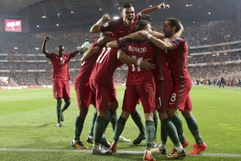 Portugal's Andre Silva celebrates with his teammates after scoring goal during the World Cup Group B qualifying soccer match between Portugal and Switzerland at the Luz stadium in Lisbon, Tuesday, Oct. 10, 2017. (AP Photo/Armando Franca)