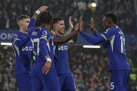 Chelsea's Nicolas Jackson celebrates with teammates after scoring his side's opening goal during the English Premier League soccer match between Chelsea and Newcastle at Stamford Bridge stadium in London, Monday, March 11, 2024. (AP Photo/Ian Walton)