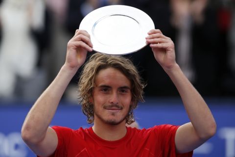 Greece's Stefanos Tsitsipas holds his second place trophy after the Barcelona Open Tennis Tournament final in Barcelona, Spain, Sunday, April 29, 2018. Spain's Rafael Nadal defeated Tsitsipas 6-2, 6-1 in the final. (AP Photo/Manu Fernandez)
