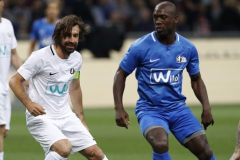 Andrea Pirlo controls the ball next to Clarence Seedorf, during Andrea Pirlo farewell exhibition match, at the Milan San Siro Stadium, Italy, Monday, May 21, 2018. (AP Photo/Antonio Calanni)