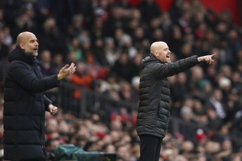 Manchester United's head coach Erik ten Hag, right, gestures next to Manchester City's head coach Pep Guardiola during the English Premier League soccer match between Manchester United and Manchester City at Old Trafford in Manchester, England, Saturday, Jan. 14, 2023. (AP Photo/Dave Thompson)
