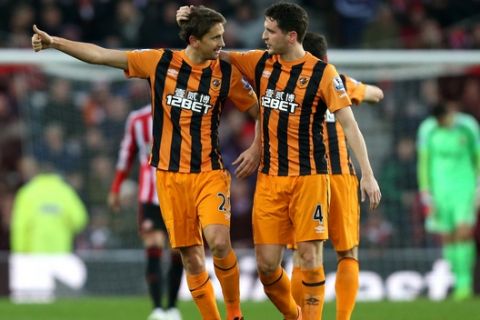 Hull City's Gaston Ramirez, left, celebrates his goal with teammate Alex Bruce, right, during their English Premier League soccer match between Sunderland and Hull City at the Stadium of Light, Sunderland, England, Friday, Dec. 26, 2014. (AP Photo/Scott Heppell)