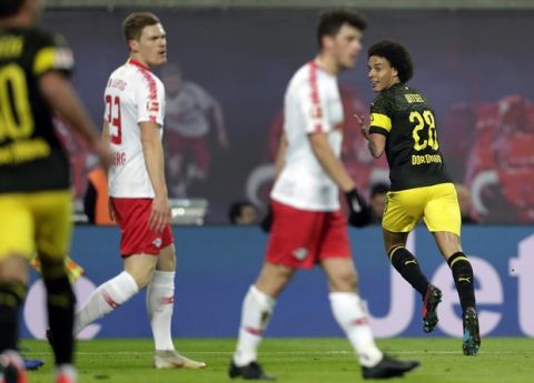 Dortmund's Axel Witsel, right, celebrates after scoring the opening goal during the German Bundesliga soccer match between RB Leipzig and Borussia Dortmund in Leipzig, Germany, Saturday, Jan. 19, 2019. (AP Photo/Michael Sohn)