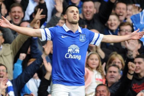 Everton's Kevin Mirallas celebrates after he scores the second goal of the game for his side during their English Premier League soccer match against Manchester United at Goodison Park in Liverpool, England, Sunday April 20, 2014. (AP Photo/Clint Hughes)  