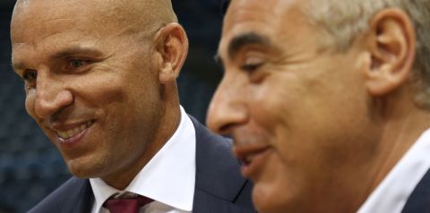 Newly named Milwaukee Bucks head NBA basketball coach Jason Kidd, left, smiles as Bucks co-owner Marc Lasry, right, speaks to the media after a press conference Wednesday, July 2, 2014, in Milwaukee. (AP Photo/Jeffrey Phelps) 
