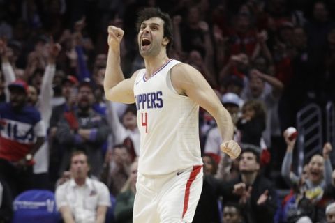 Los Angeles Clippers' Milos Teodosic celebrates his three-point basket during the second half of an NBA basketball game against the Toronto Raptors Monday, Dec. 11, 2017, in Los Angeles. The Clippers won 96-91. (AP Photo/Jae C. Hong)