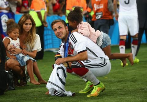 RIO DE JANEIRO, BRAZIL - JULY 13: Mario Goetze of Germany celebrates with girlfriend Ann-Kathrin Brommel and Jerome Boateng's twin daughters after defeating Argentina 1-0 in extra time during the 2014 FIFA World Cup Brazil Final match between Germany and Argentina at Maracana on July 13, 2014 in Rio de Janeiro, Brazil.  (Photo by Julian Finney/Getty Images)