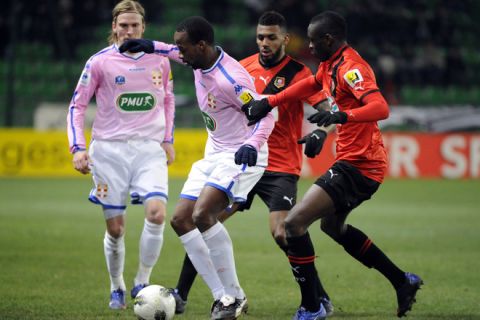 Evian's French forward Sidney Govou (2L) fights for the ball with Rennes' French defender Chris Mavinga (L) next to Rennes' French midfielder Yann M'Vila (2R) during the French cup football match Rennes against Evian-Thonon  on February 07, 2012 at the route de Lorient stadium in Rennes, western France. AFP PHOTO DAMIEN MEYER (Photo credit should read DAMIEN MEYER/AFP/Getty Images)