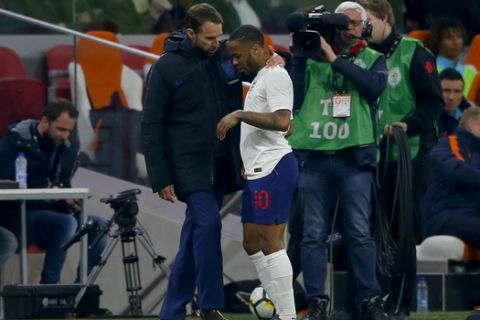 England's head coach Gareth Southgate speaks with Raheem Sterling after he was substituted during the international friendly soccer match between the Netherlands and England at the Amsterdam ArenA in Amsterdam, Netherlands, Friday, March 23, 2018. (AP Photo/Peter Dejong)