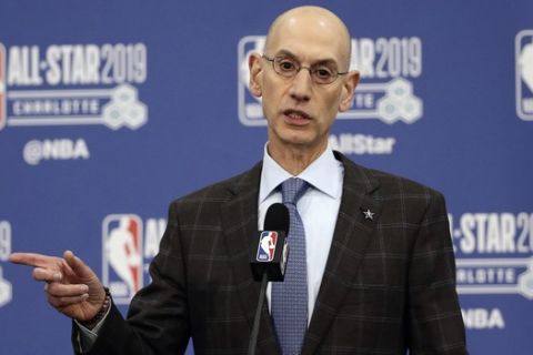 FILE - In this Feb. 16, 2019, file photo, NBA Commissioner Adam Silver speaks during NBA All-Star festivities in Charlotte, N.C. A person with knowledge of the matter says that the NBA recently sent a proposal to the National Basketball Players Association about lowering the minimum age to enter the NBA Draft from 19 to 18, as the sides continuing moving toward eliminating the "one-and-done" policy that has many elite players going to college for one season. (AP Photo/Gerry Broome, File)