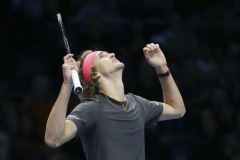 Alexander Zverev of Germany celebrates winning match point against Roger Federer of Switzerland in their ATP World Tour Finals singles tennis match at the O2 Arena in London, Saturday Nov. 17, 2018. (AP Photo/Tim Ireland)
