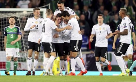 Germany's Sebastian Rudy, fourth from left, celebrates scoring his side's first goal of the game with his team-mates during the World Cup Group C qualifying soccer match between Germany and Northern Ireland at Windsor Park, Belfast, Northern Ireland. Thursday, Oct. 5, 2017. (Brian Lawless/PA via AP)