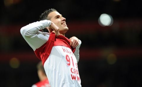 Arsenal's Dutch striker Robin Van Persie celebrates scoring the equalising goal during their English Premier League football match against Manchester United at the Emirates Stadium in London, England on January 22, 2012. AFP PHOTO/ADRIAN DENNIS  
                                                                                                             
RESTRICTED TO EDITORIAL USE. No use with unauthorized audio, video, data, fixture lists, club/league logos or ???live??? services. Online in-match use limited to 45 images, no video emulation. No use in betting, games or single club/league/player publications. (Photo credit should read ADRIAN DENNIS/AFP/Getty Images)