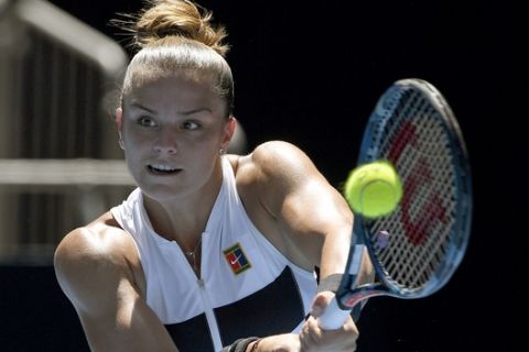 Greece's Maria Sakkari hits a backhand return to Latvia's Jelena Ostapenko during their first round match at the Australian Open tennis championships in Melbourne, Australia, Monday, Jan. 14, 2019. (AP Photo/Andy Brownbill)