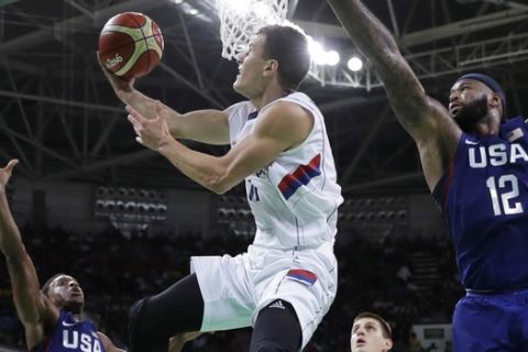 Serbia's Nemanja Nedovic (11) drives to the basket as United States' DeMarcus Cousins (12) and United States' Kyle Lowry (7) defend during the men's gold medal basketball game at the 2016 Summer Olympics in Rio de Janeiro, Brazil, Sunday, Aug. 21, 2016. (AP Photo/Eric Gay)