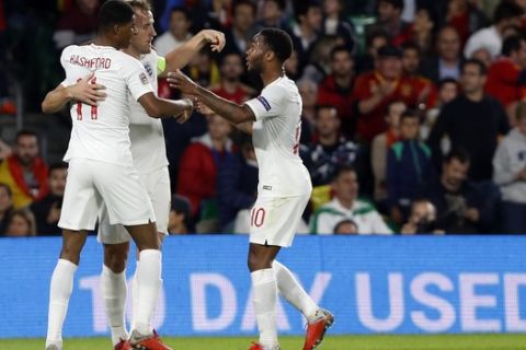 England's Marcus Rashford, left, celebrates after scoring his side's second with Raheem Sterling, right, and Hary Kane during the UEFA Nations League soccer match between Spain and England at Benito Villamarin stadium, in Seville, Spain, Monday, Oct. 15, 2018. (AP Photo/Miguel Morenatti)