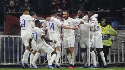 Lyon players celebrate with Lucas Tousart, center with number 29, who scored his side's first goal during a round of sixteen, first leg, soccer match between Lyon and Juventus at the at the Lyon Olympic Stadium in Decines, outside Lyon, France, Wednesday, Feb. 26, 2020. (AP Photo/Laurent Cipriani)