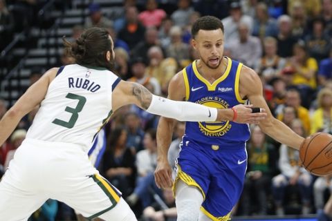 Golden State Warriors guard Stephen Curry, right, drives around Utah Jazz guard Ricky Rubio (3) in the first half during an NBA basketball game Friday, Oct. 19, 2018, in Salt Lake City. (AP Photo/Rick Bowmer)