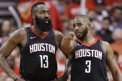 Houston Rockets guard Chris Paul (3) talks to guard James Harden during the second half in Game 2 of a first-round NBA basketball playoff series against the Minnesota Timberwolves, Wednesday, April 18, 2018, in Houston. (AP Photo/Eric Christian Smith)