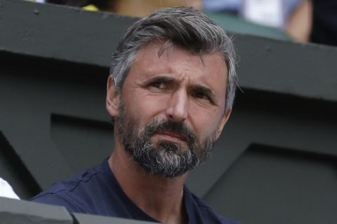 FILE - This July 1, 2019, file photo shows former Wimbledon champion Goran Ivanisevic watching a men's singles match between Novak Djokovic and Philip Kohlschreiber at the Wimbledon Tennis Championships in London. Ivanisevic has gained the most fan votes for the International Tennis Hall of Fame's Class of 2020, in voting results released Wednesday, Oct. 2, 2019. (AP Photo/Kirsty Wigglesworth, File)