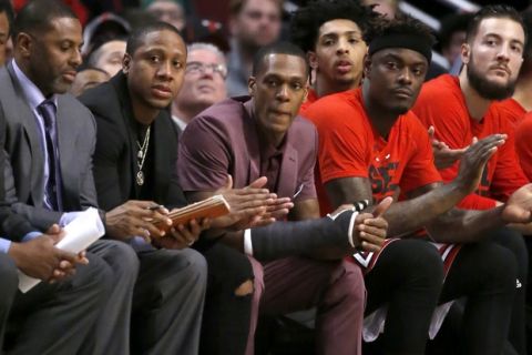With a cast on his right thumb, Chicago Bulls' Rajon Rondo, center sits on the bench during the first quarter in Game 3 of the team's NBA basketball first-round playoff series against the Boston Celtics in Chicago, Friday, April 21, 2017. (AP Photo/Charles Rex Arbogast)